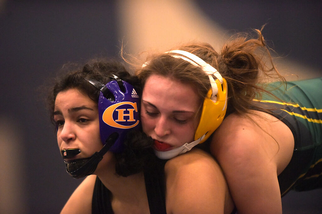 Rock Bridge's Anna Stephens, right, holds down Hickman's Danya Kassem